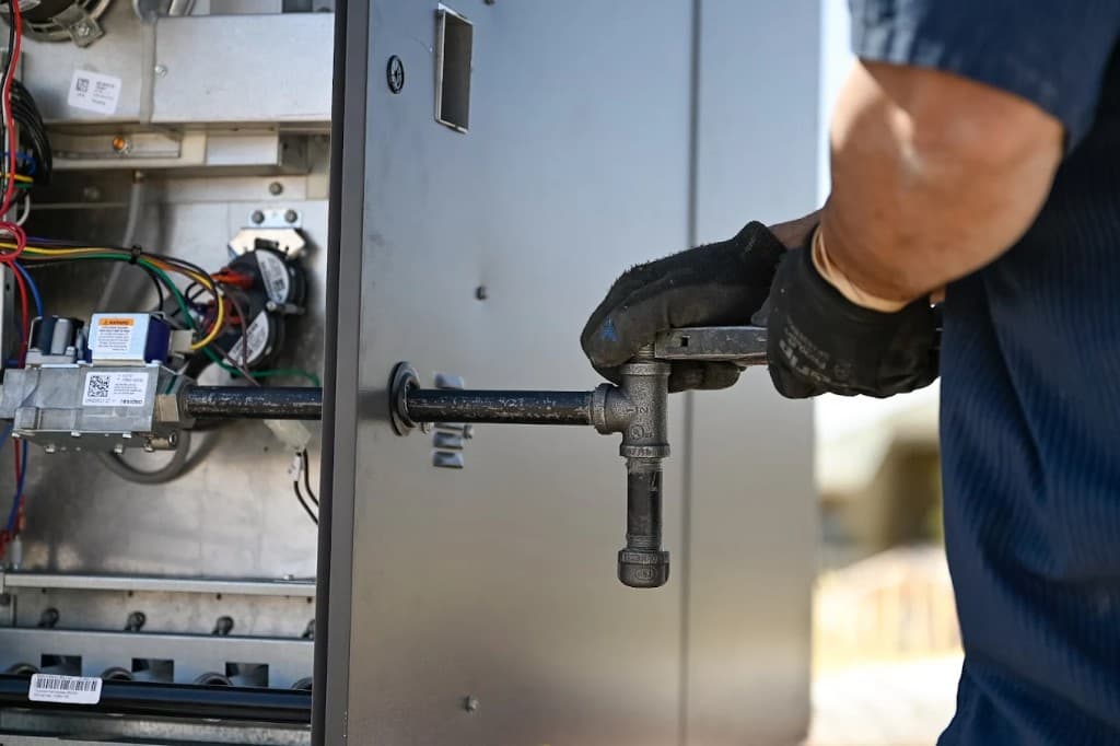 Gas Line Services in Las Vegas Valley | Active Plumbing. Technician working on gas line connections for residential heating equipment.