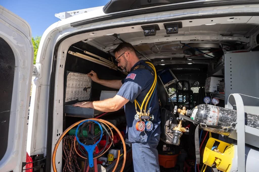 Sewage & Waste Services in Las Vegas Valley | Active Plumbing. Professional technician beside tools and stocked inventory inside an Active Plumbing service van.