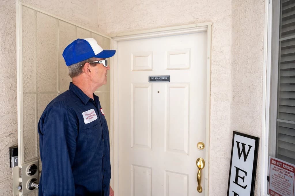 Professional plumber from Active Plumbing in Las Vegas. Uniformed Active Plumbing technician at a residential front door for a scheduled appointment.